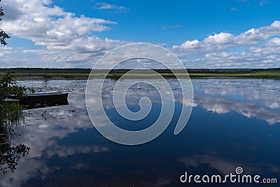 Cloud reflection in Okhotnichye Hunters Lake. Eco route in the Stock Photo