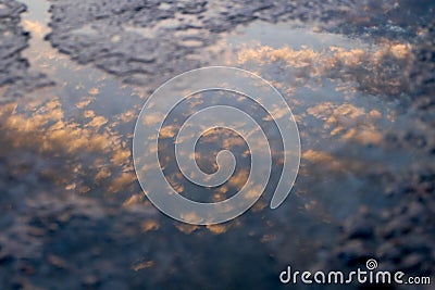 Cloud reflection in a puddle Stock Photo