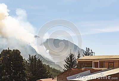 Cloud of smoke caused by a forest fire in the mountains of the Yungas region in Bolivia Stock Photo