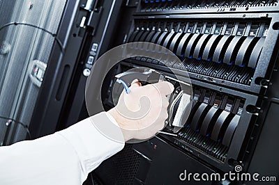 Cloud storage service. engineer replacing hard drive disk hdd in server Stock Photo