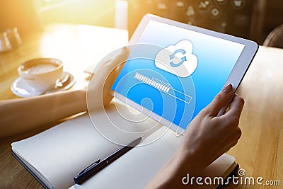 Cloud synchronization progress bar on tablet screen. Data storage and protection. Technology and internet concept. Stock Photo