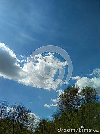 Clouds in the blue sky. Outdoor spring vertical photography Stock Photo