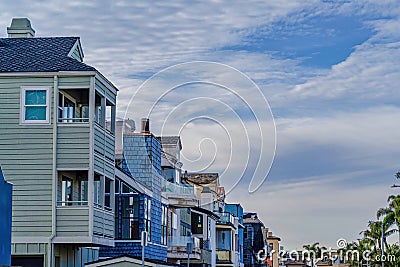 Clouds and blue sky over houses and palm trees in Huntington Beach neighborhood Stock Photo