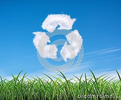 Clouds on the blue sky in shape of the symbol of recycling on green background. Protection nature and future concept. Stock Photo