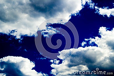 Clouds in bright dark blue sky Stock Photo