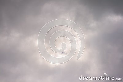 Clouds creating abstract shapes covering the sun Stock Photo