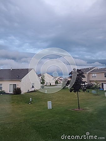 Clouds on the horizon of townhome houses Stock Photo