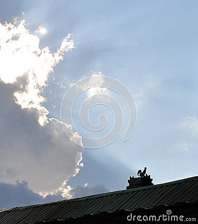 ridge of the roof with a rooster on the chimney Stock Photo