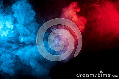 Clouds of isolated colored smoke: blue, red, orange, pink; scrolling on a black background in the dark Stock Photo