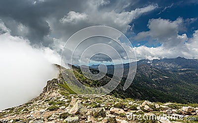 Clouds meet the top of a mountain ridge on GR20 in Corsica Stock Photo