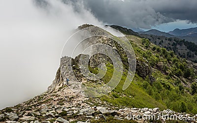 Clouds meet the top of a mountain ridge on GR20 in Corsica Stock Photo