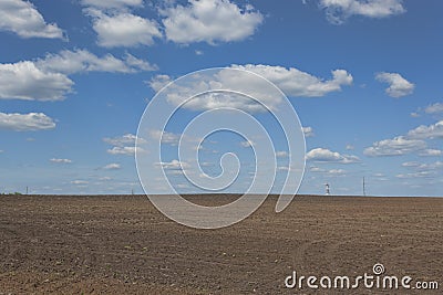 Clouds over the field that fallow land Stock Photo