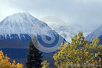 Clouds partially obscuring front range of St Elias Mountain range Stock Photo