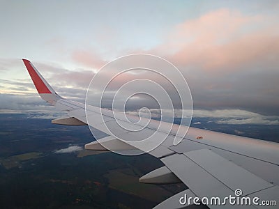 Clouds in pink rays sunset view from the plane Stock Photo