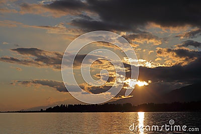 Clouds reflected on the water during sunset Stock Photo