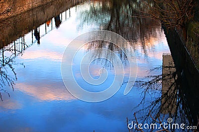 Clouds reflection at sunset Stock Photo