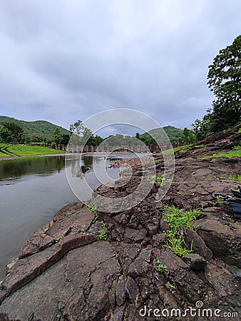 Clouds river bridge and green hills during monsoon Stock Photo