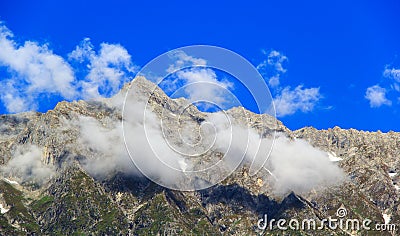 Clouds in the snowy mountains near Manali in Himalayas. Stock Photo