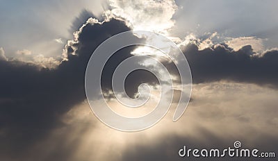 Clouds of unusual interesting shape close the sun. It`s like an abstraction. It seems that chicken or duck swallow the sun Stock Photo