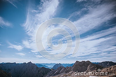 Clouds in the wind; top Zugspitze in the Wetterstein mountain, Experienced people hiking advenure under beautiful sky of Alpen Stock Photo