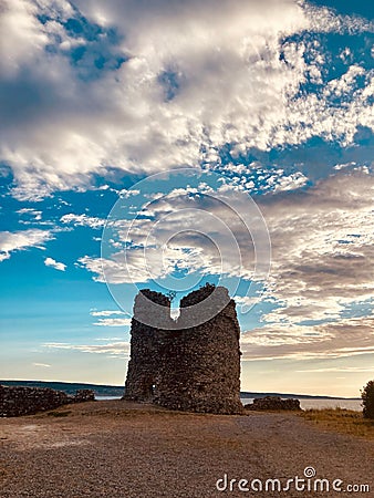 Cloudscape over the ruined bell tower, long exposure shot Stock Photo