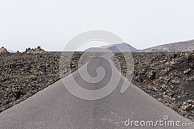 Cloudy day and road as travel background. volcanic scenery. white sky Stock Photo