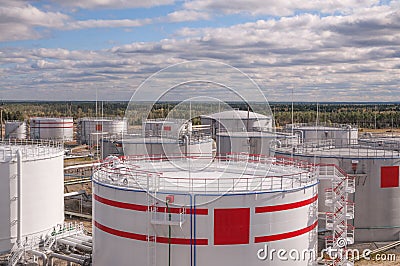 Tanks with oil for further transportation of oil through pipes at an oil refinery and oil pumping station Stock Photo