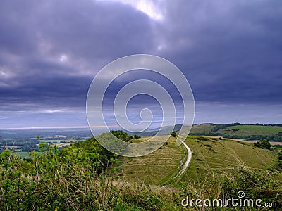 Cloudy overcast summer sunrise over the South Downs Way footpath from Beacon Hill and Harting Down in the South Downs National Stock Photo