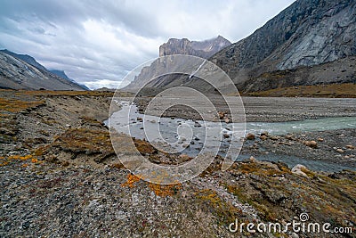 A cloudy, rainy day in remote arctic valley of Akshayuk Pass, Baffin Island, Canada. Hiking north in remote wilderness Stock Photo