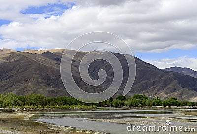 Cloudy skies cast shadows on the Himalayan mountains and the Yarlung Tsangpo River and Tibetan Plateau along Brahmaputra Valley, i Stock Photo