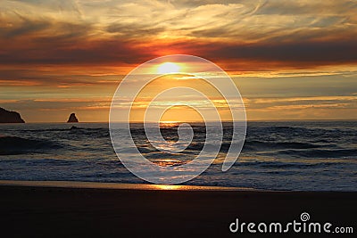 Cloudy skies and sunset over Oregon Coast Pacific ocean rocky outcrops Stock Photo