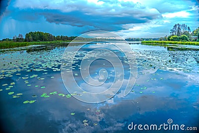 Cloudy sky over the lake. Rainy summer day. Stock Photo