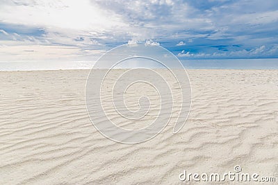 Cloudy tropical landscape. Beach view with sand and sea under overcast sky Stock Photo