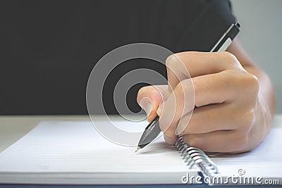 Clouse up. A hand pen writing on notebook Stock Photo