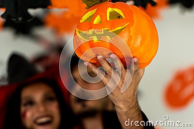 Clouse up pumpkin. Young couple party and celebrate with Halloween pumpkin and cocktails Stock Photo