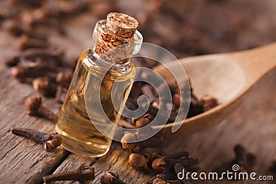 Clove oil in a bottle close-up on the table, rustic Stock Photo