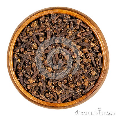 Cloves, dried aromatic flower buds, in a wooden bowl Stock Photo