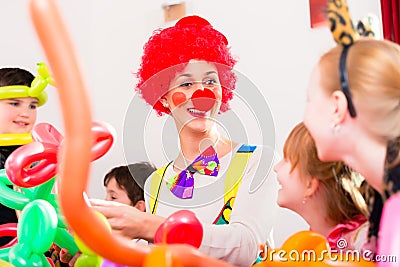 Clown at children birthday party with kids Stock Photo