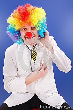 Clown doctor on blue with stethoscope Stock Photo