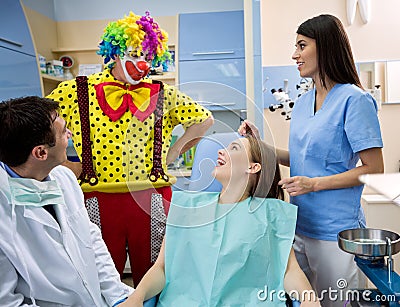 Clown entertains girl in dental ambulance Stock Photo