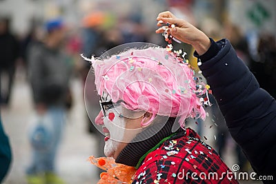 Clown playing with confetti in the street Editorial Stock Photo