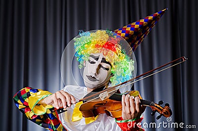 Clown playing on violin Stock Photo