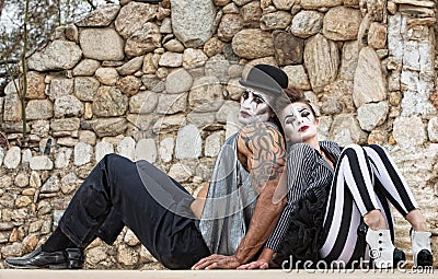 Clowns Sitting Back to Back Stock Photo