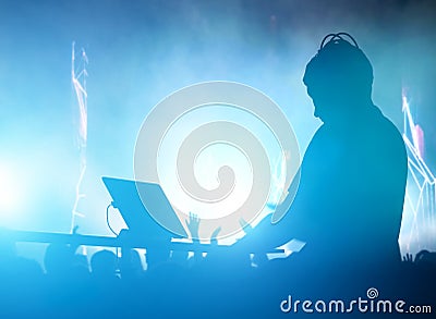 Club, disco DJ playing and mixing music for people. Nightlife Stock Photo