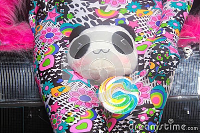 Club party blonde girl in acid anime style spandex catsuit with mirror car with pink fur ready for crazy clubbing life Stock Photo