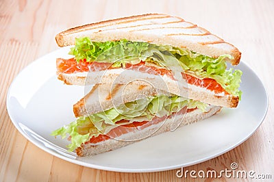 Club sandwich with salmon, cheese, lettuce Stock Photo