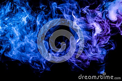 Clubs of colored smoke of blue and pink color on a black isolated background in the form of clouds from the vape Stock Photo