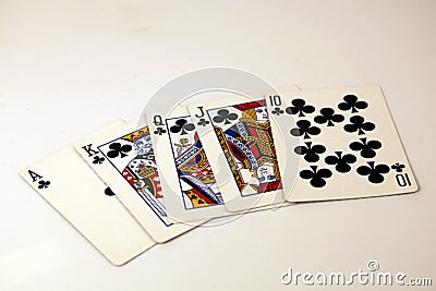 Clubs royal flush poker hand in black Stock Photo