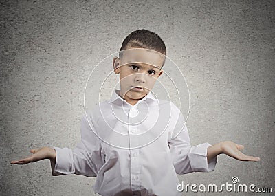 Clueless child boy with arms out asking what's problem Stock Photo