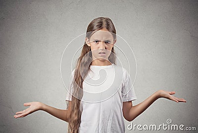 Clueless teenager girl shrugs shoulders Stock Photo